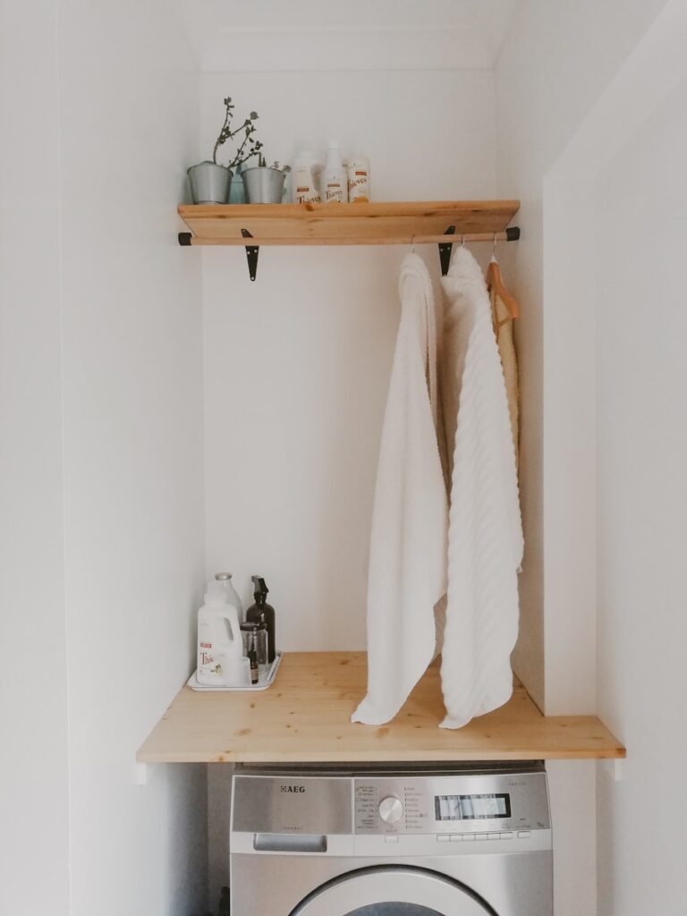 white bath towel on brown wooden table