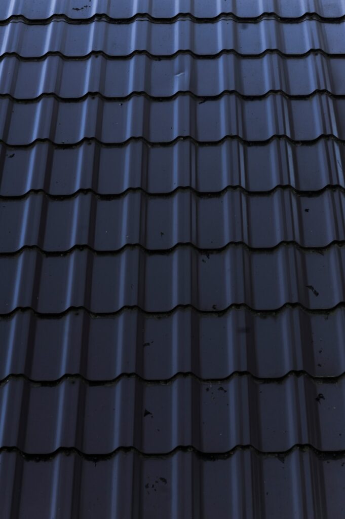a close up of a metal roof with a sky background